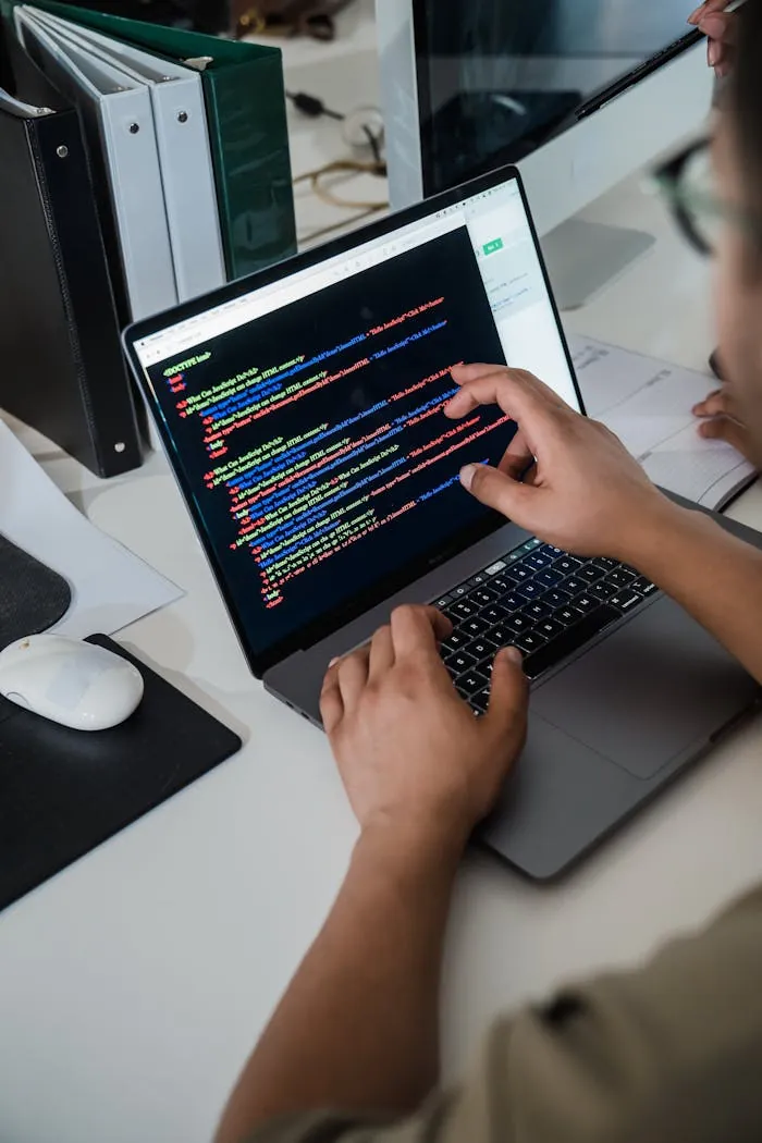 Developer writing code on a laptop